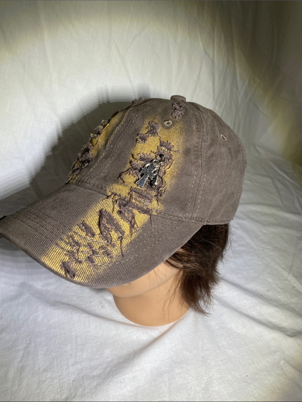 Distressed Brown Baseball Cap with Yellow Accents and Metal Charm